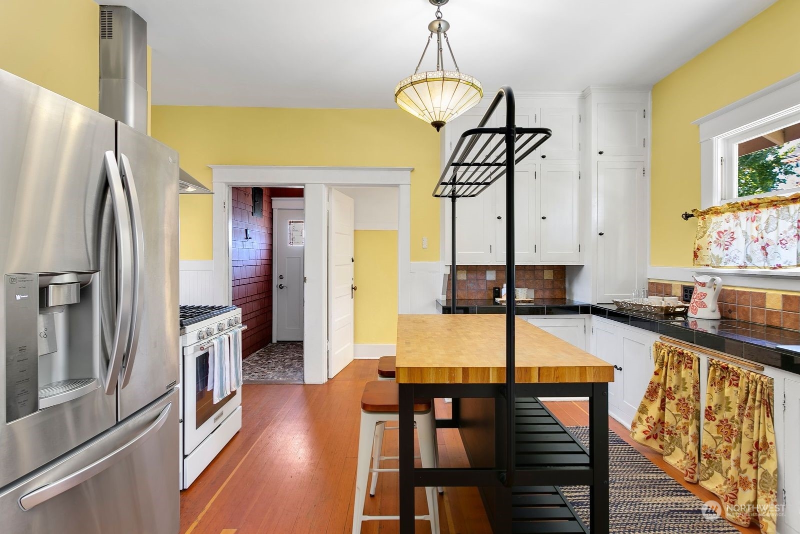 3102 8th Street Everett, WA 98201 - Photo 9 of 22 a view of a dining room with furniture a chandelier and wooden floor