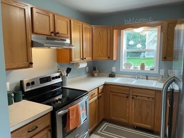 a kitchen with stainless steel appliances a sink stove and cabinets