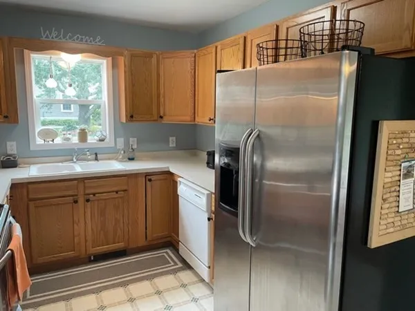a kitchen with stainless steel appliances granite countertop a refrigerator and a sink