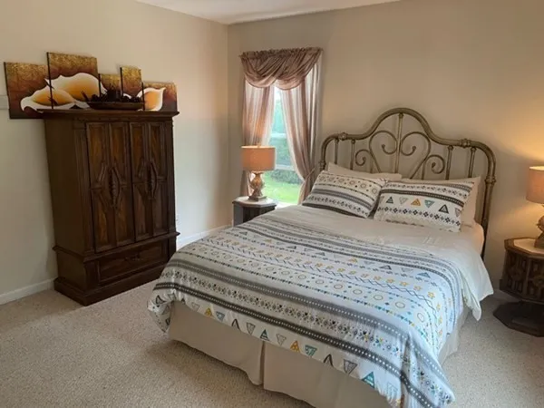 a bedroom with a bed and a dresser
