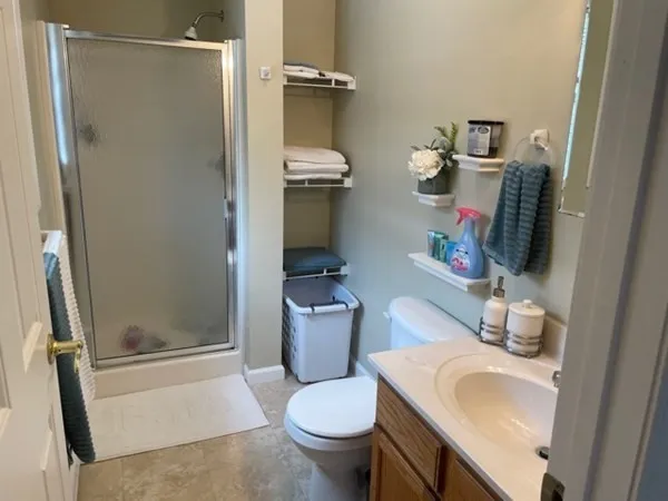 a bathroom with a sink toilet and shower