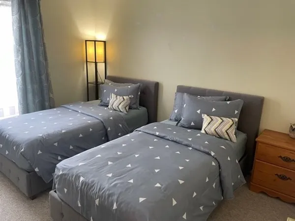 a bedroom with double bed and window