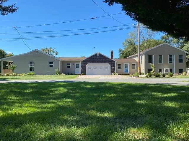 a front view of a house with a garden