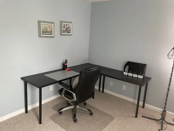 a view of a workspace with furniture