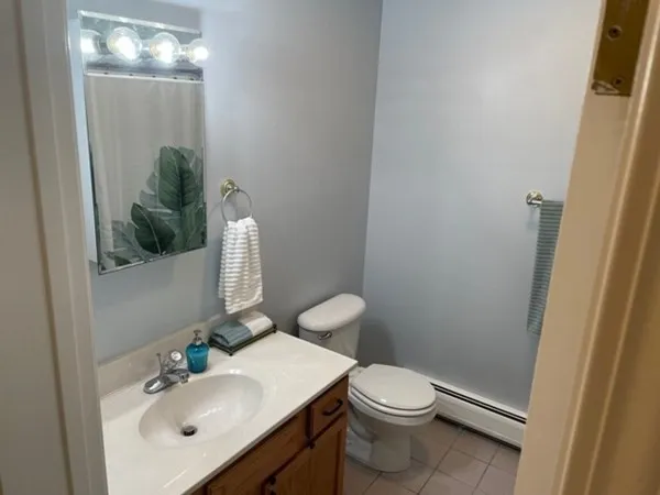 a bathroom with a sink vanity mirror and toilet
