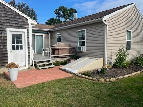 a view of a house with backyard and sitting area