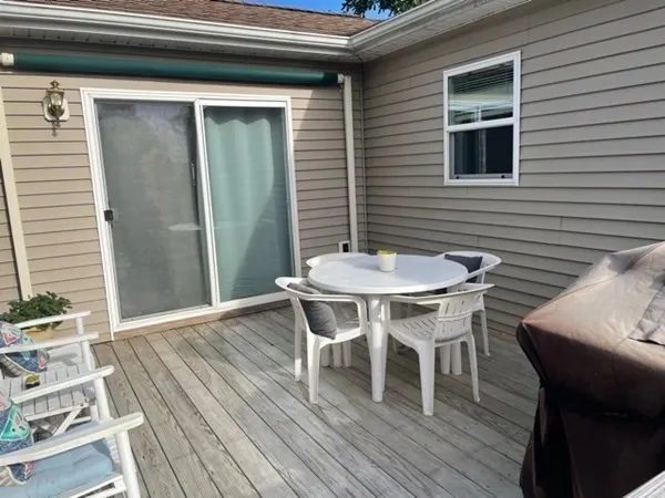 a patio with wooden floor and a table