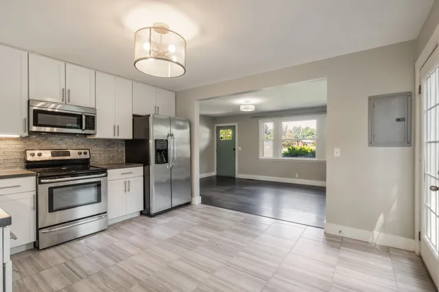 a view of kitchen with sink and stainless steel appliances