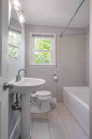 a bathroom with a sink a toilet and a bathtub