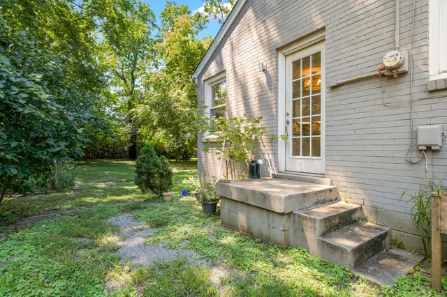a view of house with backyard and garden