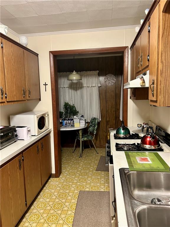 514 South Washington Street Butler, PA 16001 - Photo 12 of 27 a kitchen with a sink and a stove top open