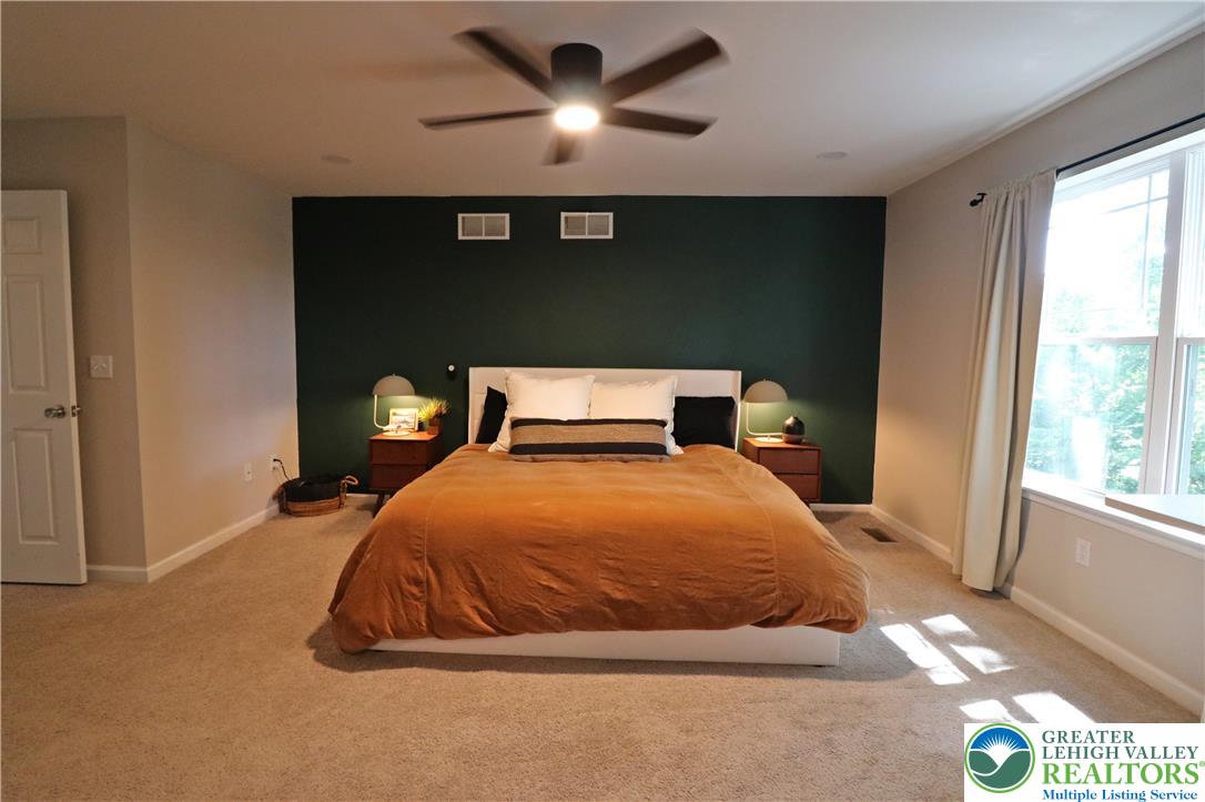 4502 Benjamin Court Emmaus, PA 18049 - Photo 26 of 53 A spacious bedroom features plush carpeting and a modern ceiling fan, creating a comfortable retreat.