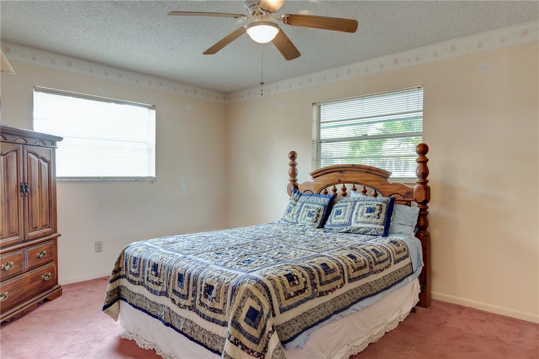 325 Perch Lane Sebastian, FL 32958 - Photo 12 of 26 a bedroom with a bed couch and window