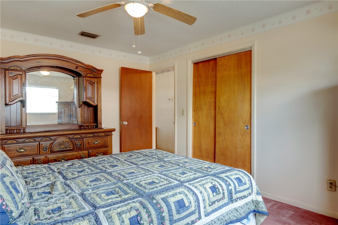 325 Perch Lane Sebastian, FL 32958 - Photo 13 of 26 a bedroom with a bed and a dresser