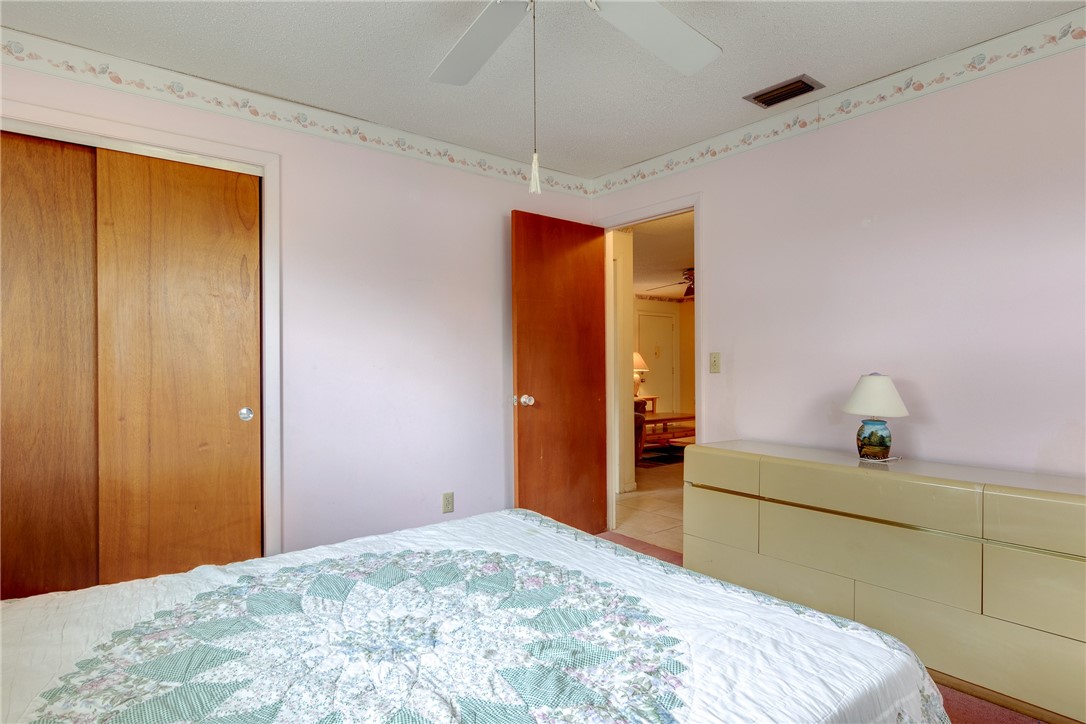 325 Perch Lane Sebastian, FL 32958 - Photo 16 of 26 a bedroom with a bed and a dresser in it