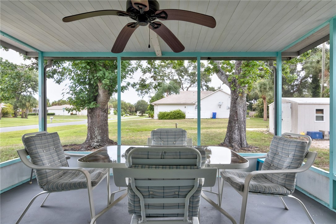 325 Perch Lane Sebastian, FL 32958 - Photo 18 of 26 a view of a patio with couches chairs dining table and chairs