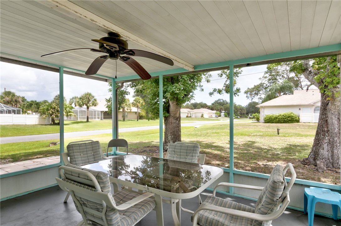 325 Perch Lane Sebastian, FL 32958 - Photo 20 of 26 a dining room with furniture and floor to ceiling windows