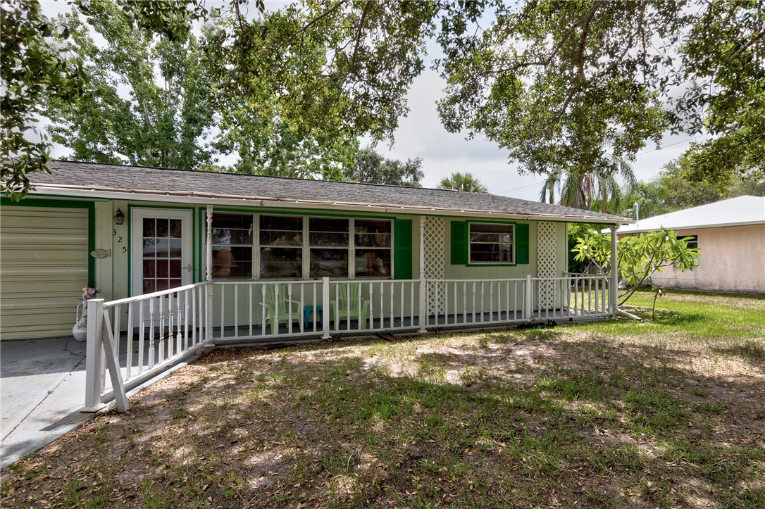325 Perch Lane Sebastian, FL 32958 - Photo 2 of 26 a view of a house with a yard and a large tree