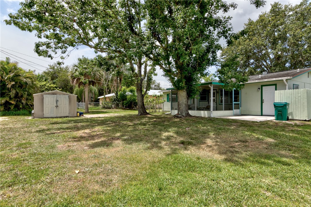 325 Perch Lane Sebastian, FL 32958 - Photo 22 of 26 a backyard of a house with fountain and tree