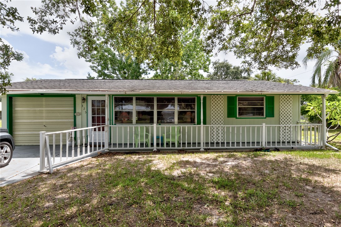 325 Perch Lane Sebastian, FL 32958 - Photo 3 of 26 a view of a house with a yard and a large tree