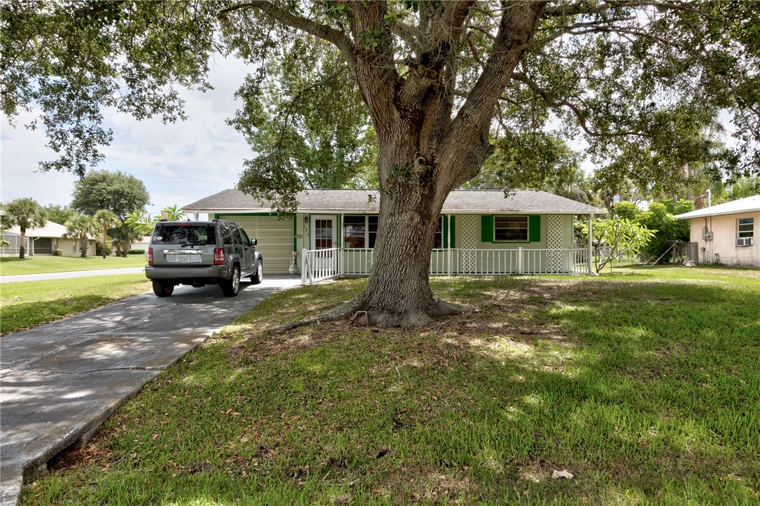 325 Perch Lane Sebastian, FL 32958 - Photo 4 of 26 a front view of a house with a garden
