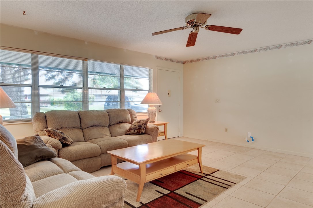 325 Perch Lane Sebastian, FL 32958 - Photo 6 of 26 a living room with furniture a window and a ceiling fan