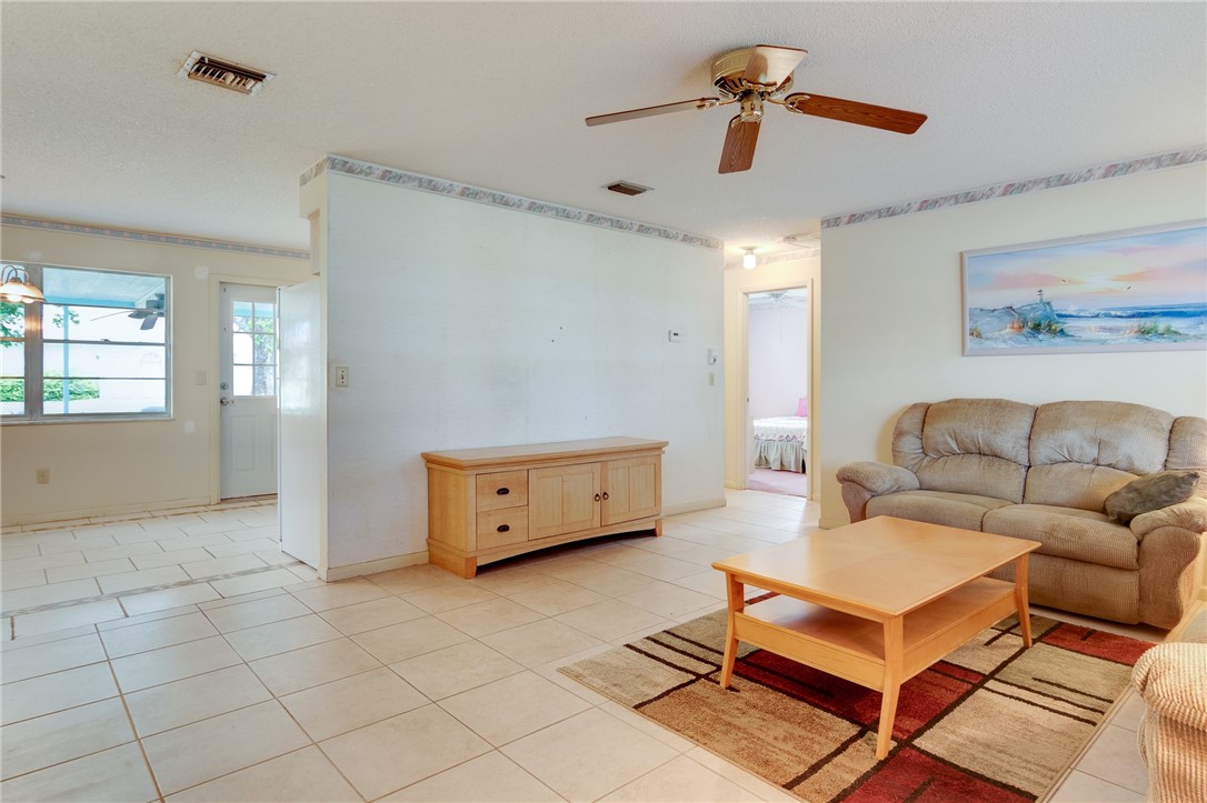 325 Perch Lane Sebastian, FL 32958 - Photo 7 of 26 a living room with furniture and a ceiling fan