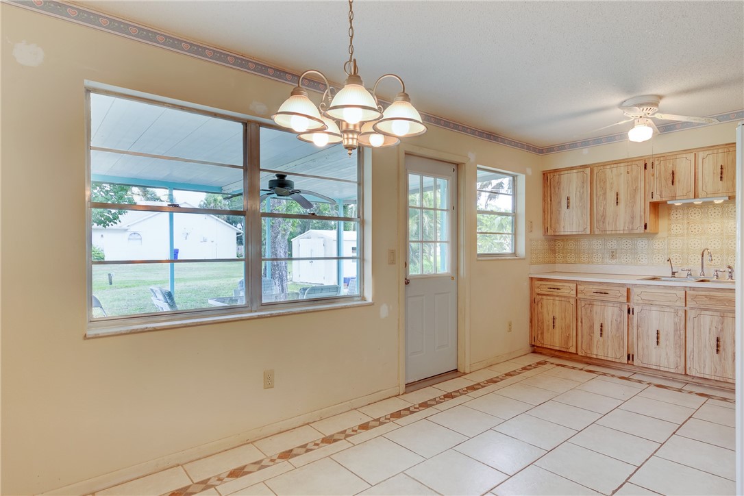 325 Perch Lane Sebastian, FL 32958 - Photo 10 of 26 a kitchen with a refrigerator a sink and dishwasher with a large window