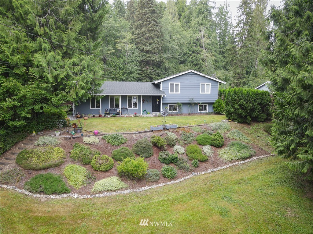 15911 OK Mill Road Snohomish, WA 98290 - Photo 1 of 40 a front view of a house with a yard and trees