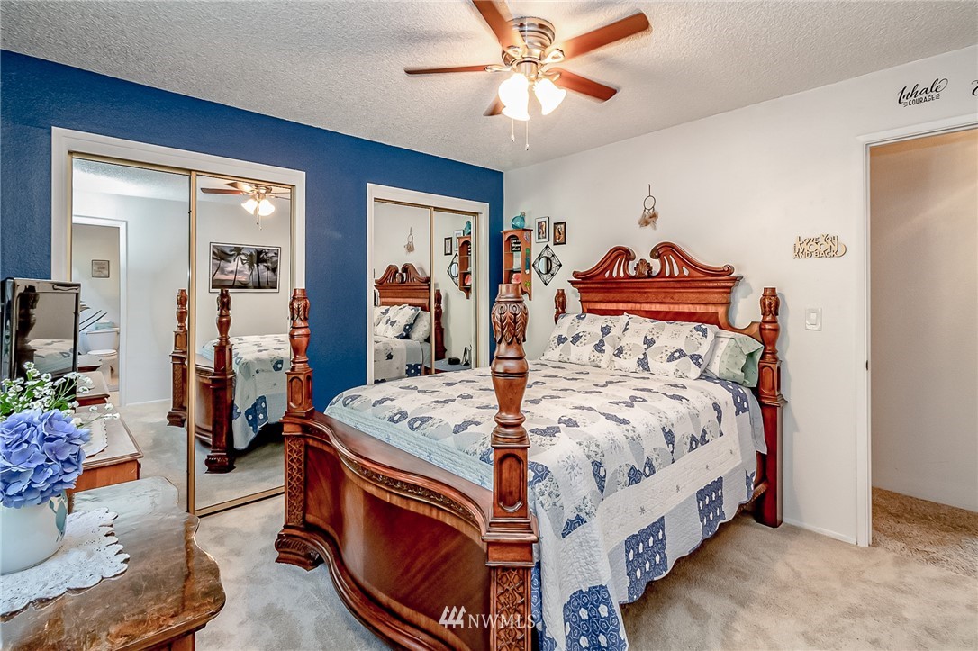 15911 OK Mill Road Snohomish, WA 98290 - Photo 13 of 40 a bedroom with a bed and a chandelier
