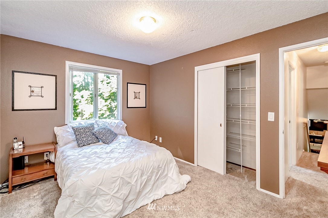 15911 OK Mill Road Snohomish, WA 98290 - Photo 18 of 40 a bedroom with a large bed and a window