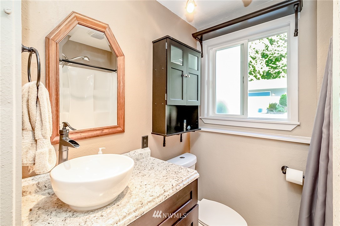 15911 OK Mill Road Snohomish, WA 98290 - Photo 20 of 40 a bathroom with a granite countertop sink mirror vanity and toilet