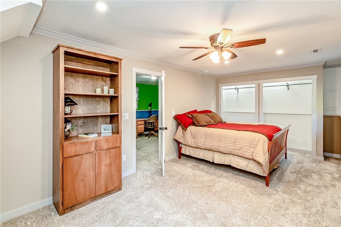 15911 OK Mill Road Snohomish, WA 98290 - Photo 22 of 40 a bedroom with a bed and a window