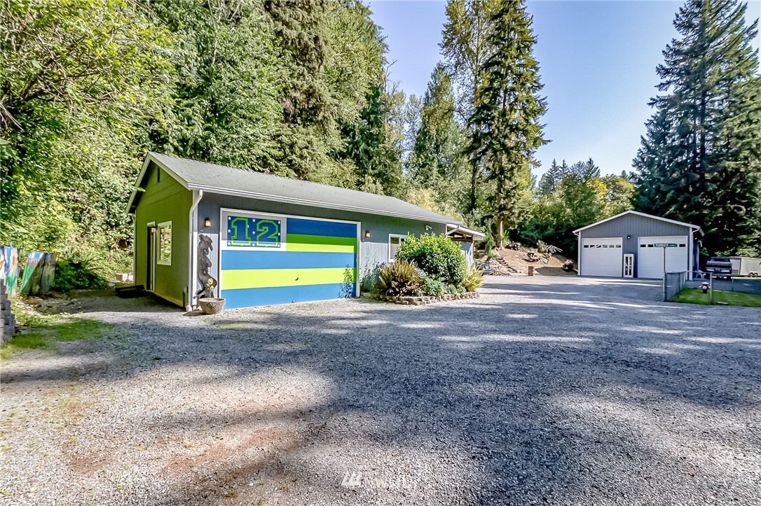 15911 OK Mill Road Snohomish, WA 98290 - Photo 25 of 40 a front view of a house with a yard and garage