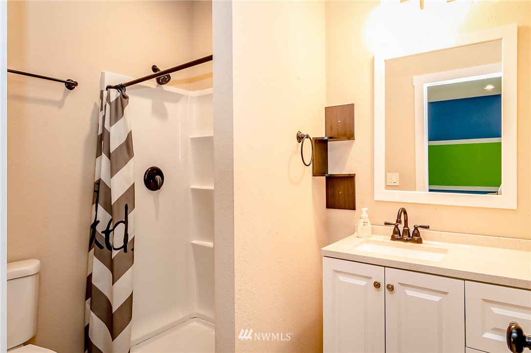 15911 OK Mill Road Snohomish, WA 98290 - Photo 30 of 40 a bathroom with a shower sink and mirror