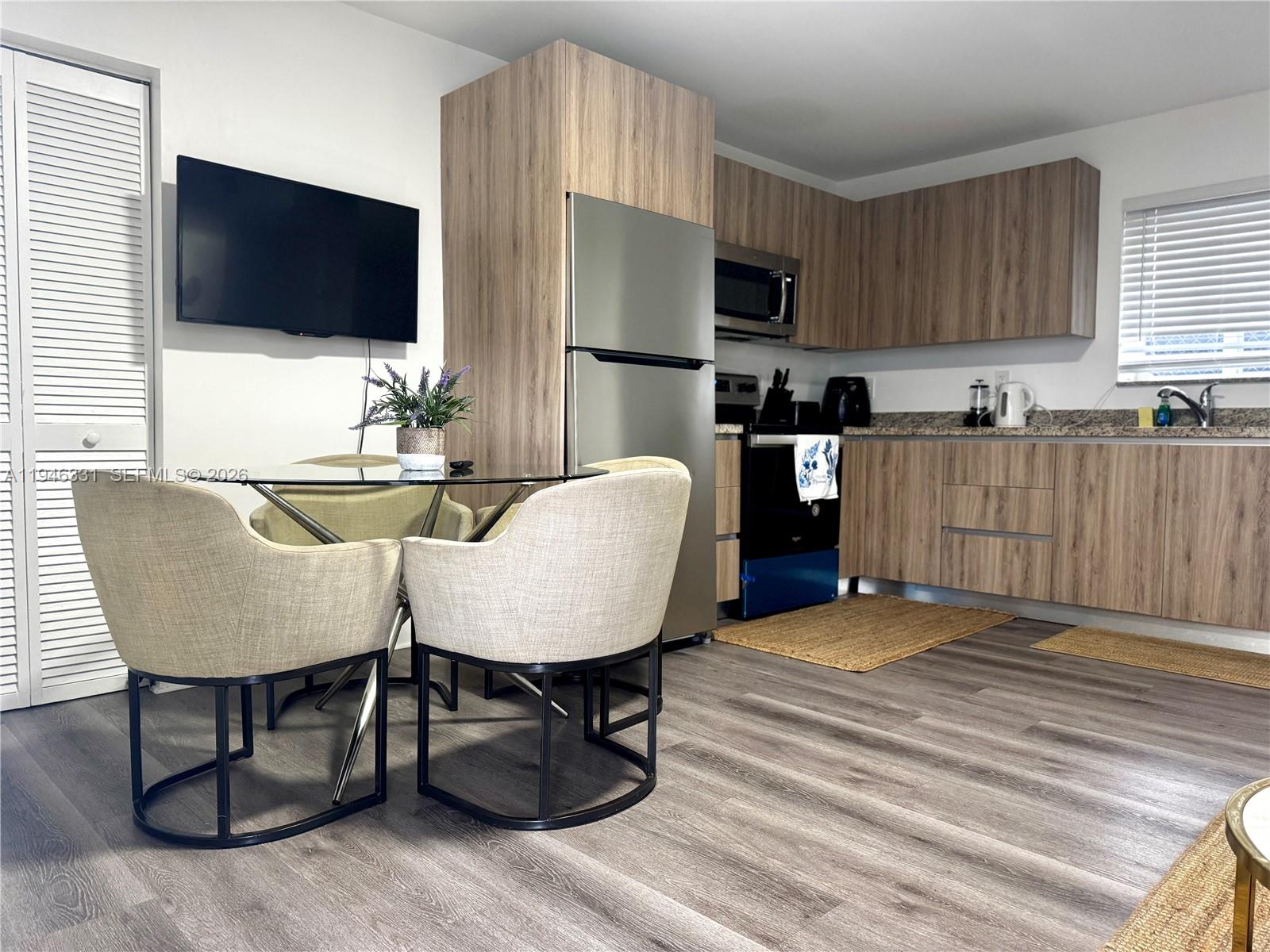 1684 Southwest 10th Street, Unit 5 Miami, FL 33135 - Photo 4 of 10 a living room with furniture and a flat screen tv