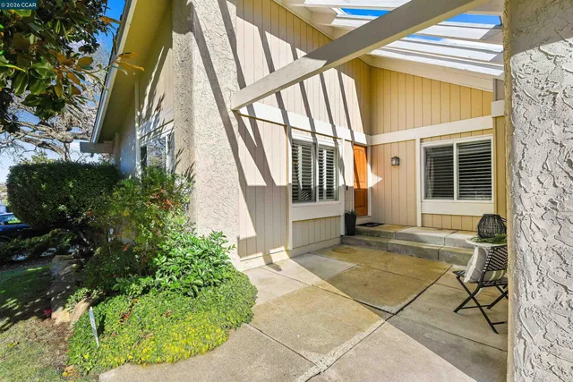 a living room with furniture a fireplace and a large window