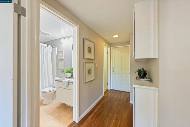 a bathroom with a granite countertop sink a mirror and a shower