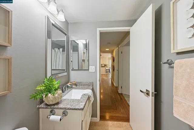 a view of a balcony with chairs and wooden floor