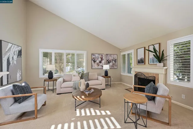 a living room with furniture fireplace and window