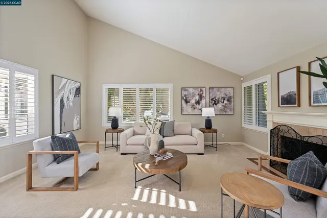a living room with furniture large window and a fireplace