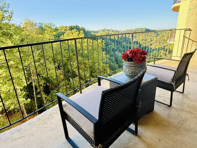 a view of a chairs and table on the balcony