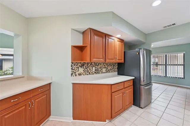 a kitchen with stainless steel appliances granite countertop a refrigerator and a stove