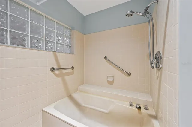 a bathroom with a tub and a shower