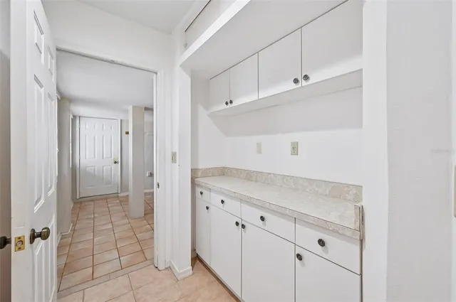 a view of a kitchen with white cabinets