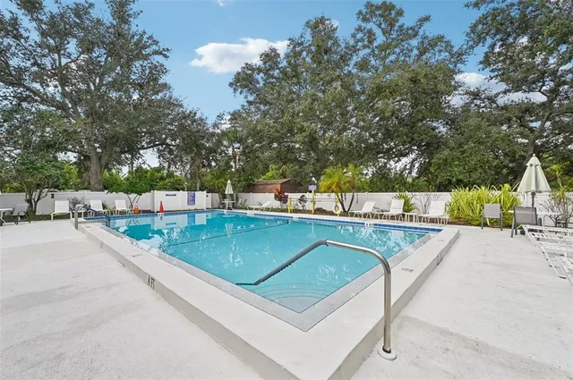 a view of a swimming pool with a patio and yard