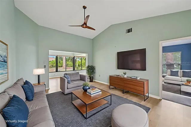 a living room with furniture flat screen tv and a fireplace
