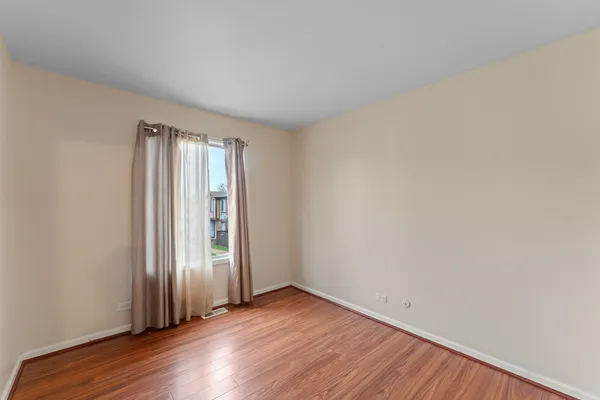 a view of a balcony with wooden floor