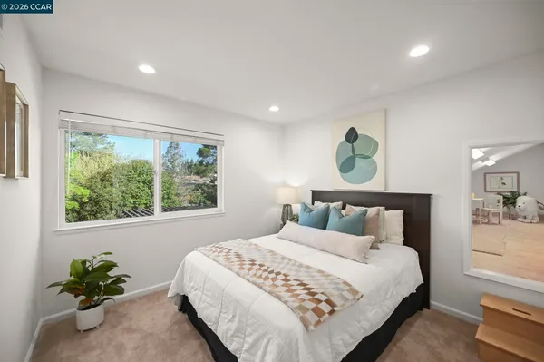 a bedroom with a bed and a window