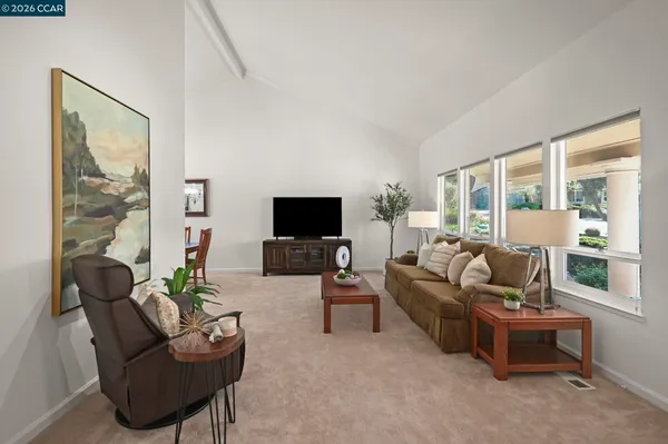 a dining room with furniture a chandelier and window